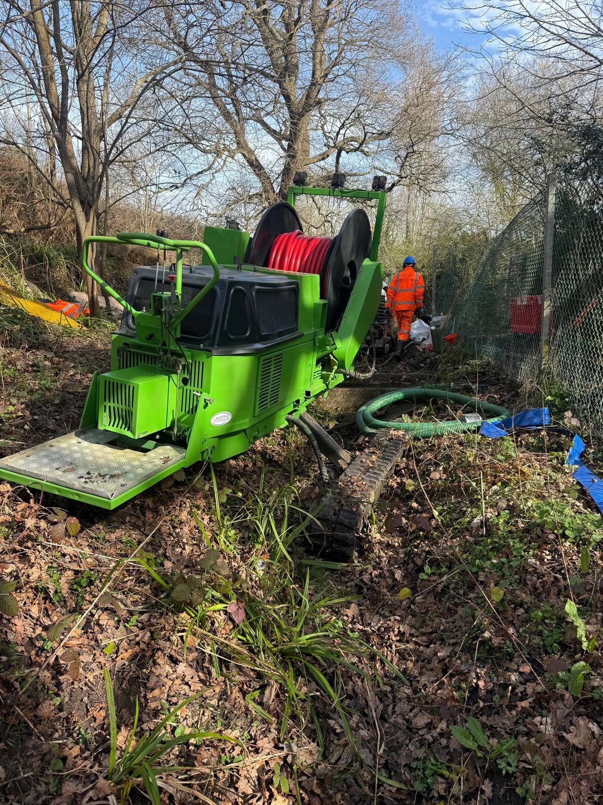 Tracked drainage equipment on site